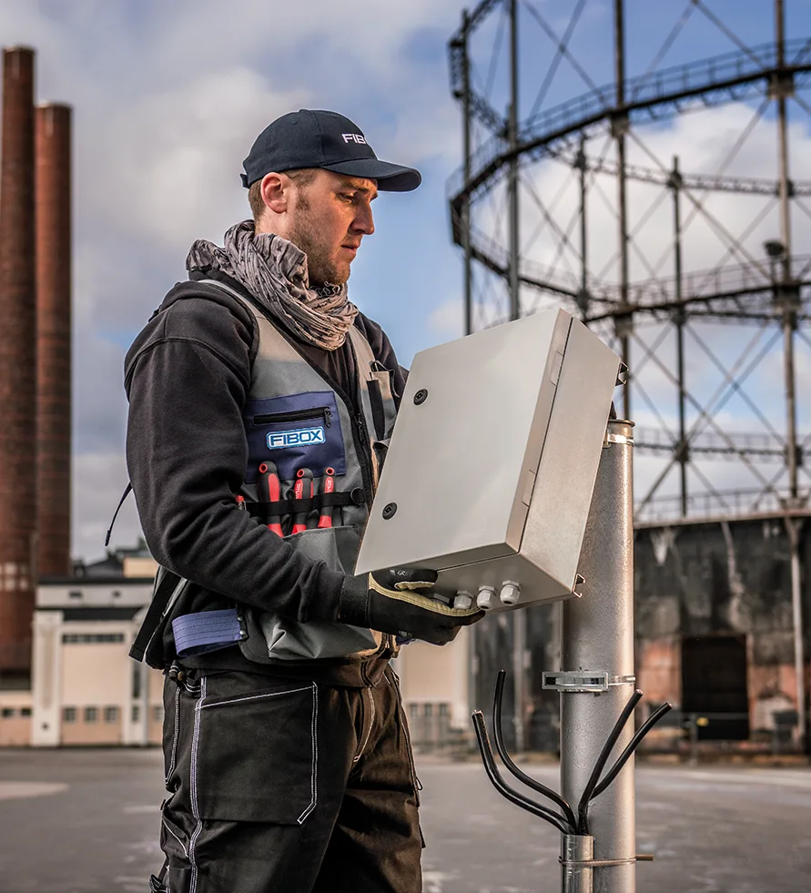 Fibox worker holding a telecom enclosure box